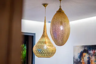two gold lights hanging from a ceiling at Modern Moroccan Apartment in Gueliz with Terrace in Marrakech