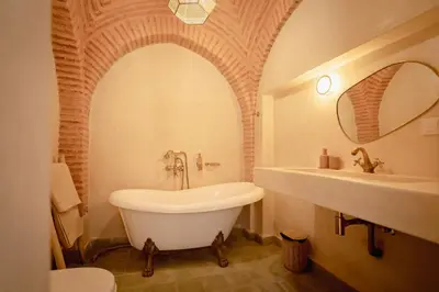 a bathroom with a white tub and a sink at Riad KECH LeS ESSENTIELS in Marrakech