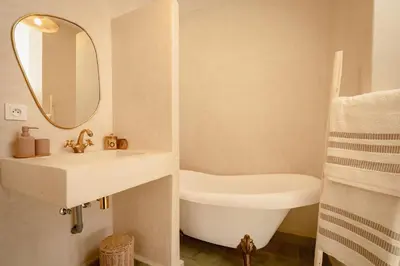 a bathroom with a sink and a tub and a mirror at Riad KECH LeS ESSENTIELS in Marrakech
