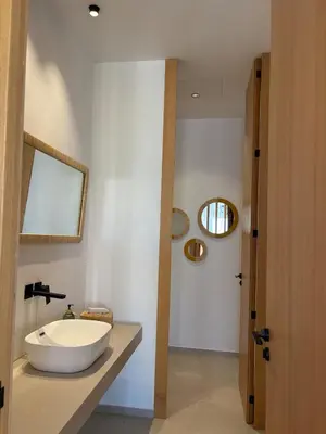 a bathroom with a white sink and a mirror at Villa Marleanis 5 suites 300m2 piscine chauffée privative 11m de long résidence avec gardien in Marrakech