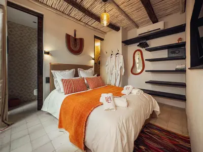 a bedroom with a large bed with towels on it at Maison Etchika in Marrakech