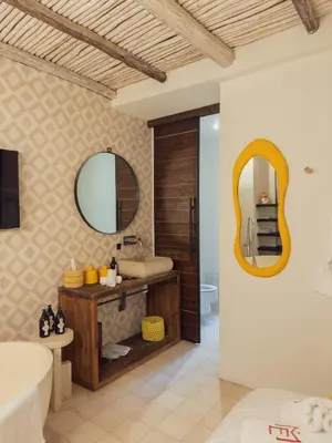a bathroom with a tub and a sink and a mirror at Maison Etchika in Marrakech