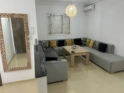 a living room with a couch and a table at Appartement 2 chambres meublé Marrakech in Marrakech