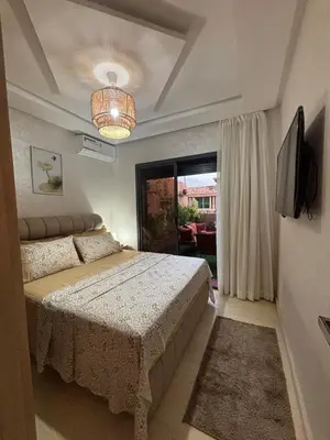 a bedroom with a bed and a large window at Terrasse & Cinéma au cœur de Marrakech in Marrakech