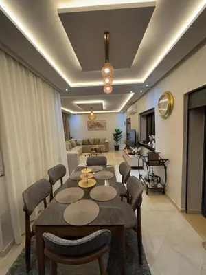 a living room with a table and chairs and a couch at Terrasse & Cinéma au cœur de Marrakech in Marrakech