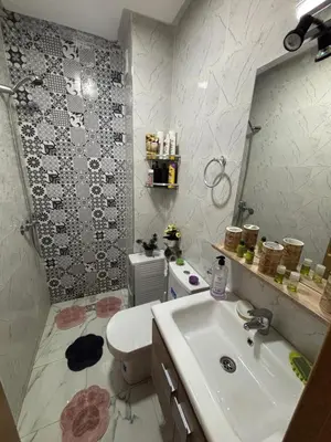 a bathroom with a sink and a toilet and a mirror at Terrasse & Cinéma au cœur de Marrakech in Marrakech