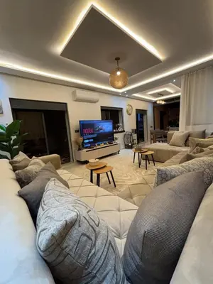 a large living room with couches and a tv at Terrasse & Cinéma au cœur de Marrakech in Marrakech