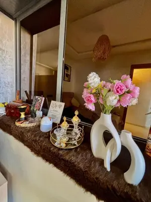 a counter with two vases with pink flowers on it at Terrasse & Cinéma au cœur de Marrakech in Marrakech