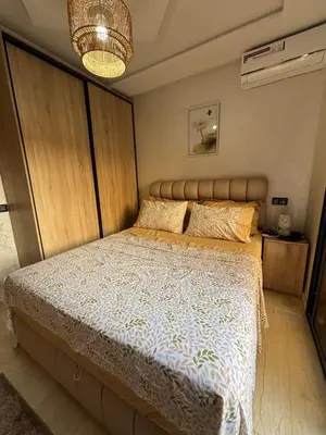 a bedroom with a large bed with a large headboard at Terrasse & Cinéma au cœur de Marrakech in Marrakech