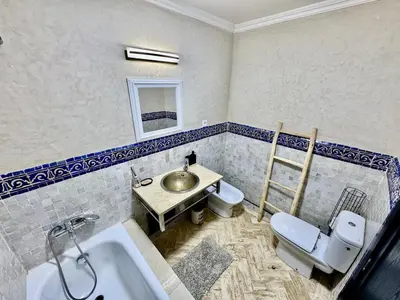 a bathroom with a sink and a toilet at Stylish Atlas Golf Resort Getaway - Free Breakfast, Rooftop Patio, Pool, Views in Marrakech