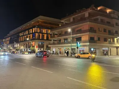 a city street at night with cars and a building at Nova Gueliz Residence in Marrakech