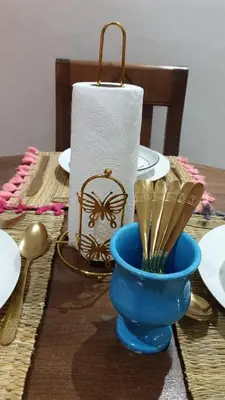a table with a blue vase and a roll of paper towels at Omar Hachoum in Marrakech