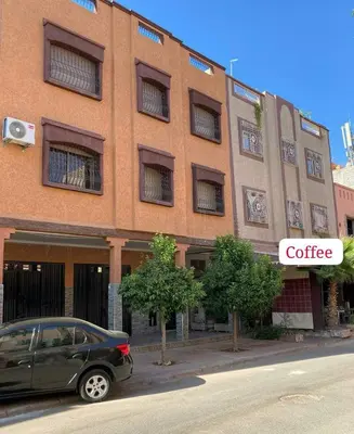 a car parked in front of a brick building at Omar Hachoum in Marrakech