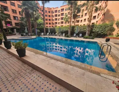a swimming pool in the middle of a building at Hivernage Bright & Spacious 2-Bedroom Apartment in Marrakech