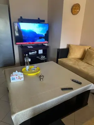 a living room with a coffee table and a tv at Hivernage Bright & Spacious 2-Bedroom Apartment in Marrakech