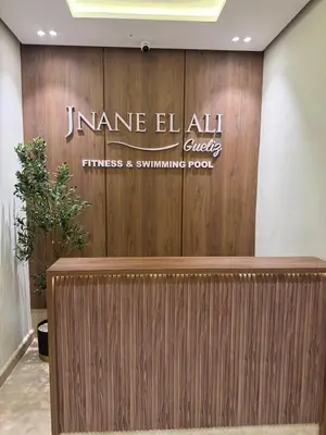 a lobby with a sign on a wooden wall at Appartement Guéliz 2 piscines, jacuzzi chauffé et fitness in Marrakech