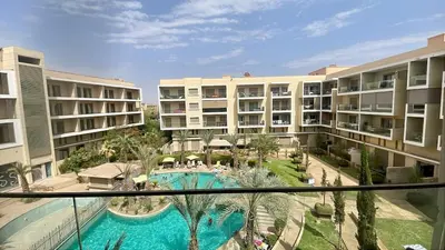 a view of a pool from an apartment building at Luxury Pastel Suite with Balcony & Pool in Marrakech