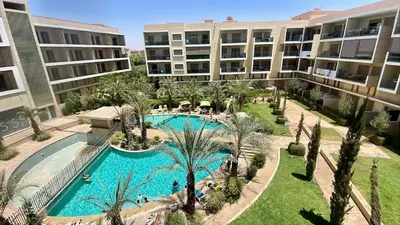 an aerial view of an apartment complex with a swimming pool at Luxury Pastel Suite with Balcony & Pool in Marrakech