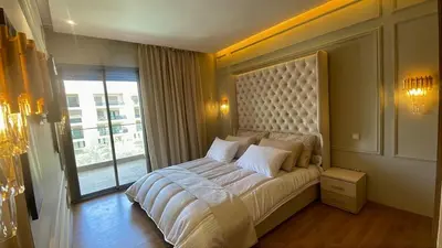 a bedroom with a large bed with a large window at Luxury Pastel Suite with Balcony & Pool in Marrakech