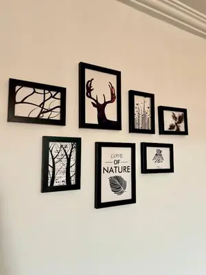 a group of framed pictures on a wall at Villa Sara in Marrakech