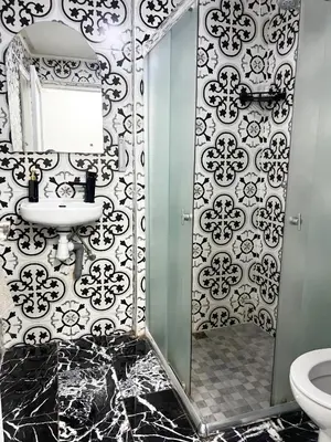 a bathroom with a shower and a sink and a toilet at Villa Sara in Marrakech