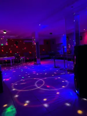 a room with blue and purple lights on a dance floor at Villa Sara in Marrakech