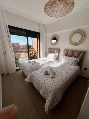 a bedroom with two beds with teddy bears on them at Appart 2 chambres Gueliz in Marrakech