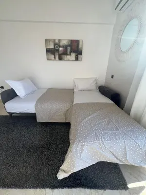 a bedroom with two beds and a window at Appart 2 chambres Gueliz in Marrakech