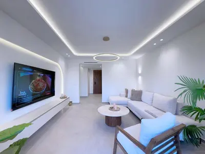 a living room with a couch and a tv on a wall at Modern & luxurious apartment in Victor Hugo, Marrakech in Marrakech