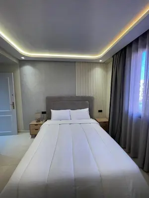 a large white bed in a room with a window at Welcome to your peaceful getaway in Marrakech! in Marrakech