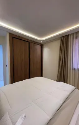 a large white bed in a room with a window at Welcome to your peaceful getaway in Marrakech! in Marrakech