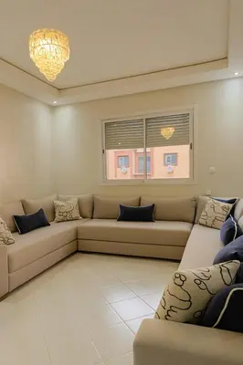 a living room with a couch and a window at Spacious Apartment Near Menara Garden and Airport in Marrakech