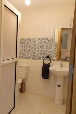 a bathroom with a toilet and a sink at Spacious Apartment Near Menara Garden and Airport in Marrakech