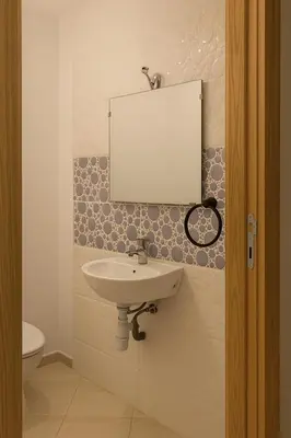 a bathroom with a sink and a mirror on the wall at Spacious Apartment Near Menara Garden and Airport in Marrakech