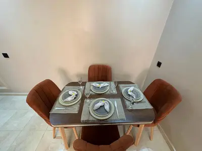 a table with chairs and plates and dishes on it at Calme & Confort Mabroka - 2 chambre in Marrakech