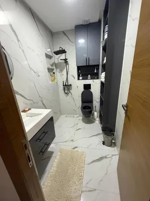 a bathroom with a sink and a toilet at Licht & ruim 2-slaapkamer appartement met airco & Wifi - rustig wijk Marrakesh in Marrakech