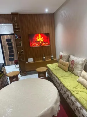 a room with a bed and a tv on the wall at Licht & ruim 2-slaapkamer appartement met airco & Wifi - rustig wijk Marrakesh in Marrakech