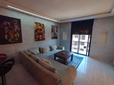 a living room with a couch and a table at kech vacations 2 bedroom luxury gulize apartment in Marrakech