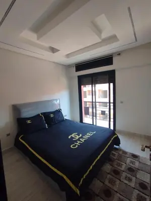 a large bed in a room with a window at kech vacations 2 bedroom luxury gulize apartment in Marrakech
