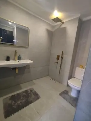 a bathroom with a toilet and a sink at kech vacations 2 bedroom luxury gulize apartment in Marrakech