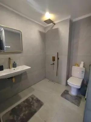 a bathroom with a toilet and a sink at kech vacations 2 bedroom luxury gulize apartment in Marrakech