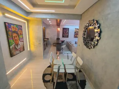a living room with a table and a couch at kech vacations 2 bedroom luxury gulize apartment in Marrakech