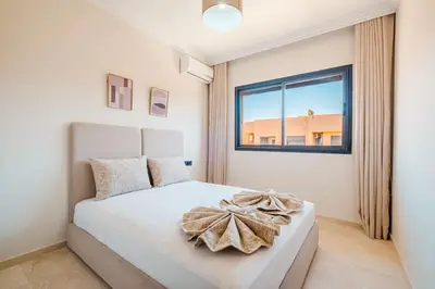 a bedroom with a white bed and a window at Modern 2 bedroom apartment Marrakech in Marrakech