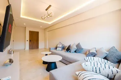 a living room with a couch and a table at Modern 2 bedroom apartment Marrakech in Marrakech