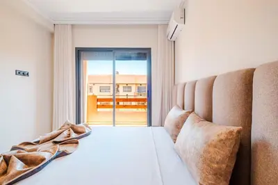 a bedroom with a bed and a large window at Modern 2 bedroom apartment Marrakech in Marrakech