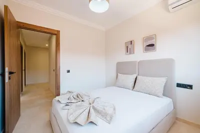 a bedroom with a white bed with a bow on it at Modern 2 bedroom apartment Marrakech in Marrakech