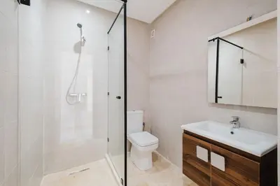 a bathroom with a shower and a toilet and a sink at Modern 2 bedroom apartment Marrakech in Marrakech