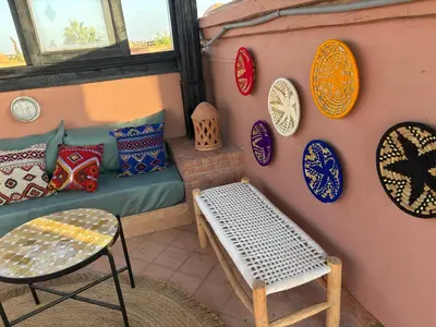 a room with a bench and plates on the wall at Atlas golf resort beldi chic piscine in Marrakech
