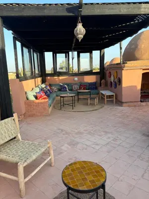 a living room with a couch and chairs on a patio at Atlas golf resort beldi chic piscine in Marrakech