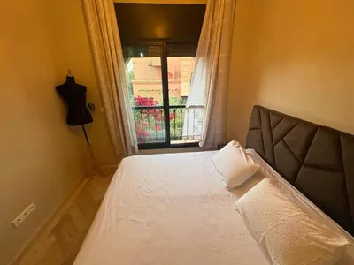 a bedroom with a large bed with a window at Atlas golf resort beldi chic piscine in Marrakech